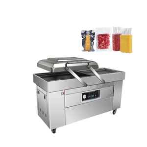 Double chamber industrial vacuum sealer for food packaging with stainless steel body and large vacuum chambers.