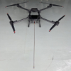 Industrial UAV performing high pressure exterior cleaning