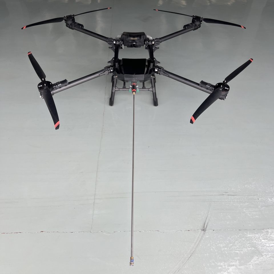 Industrial UAV performing high pressure exterior cleaning