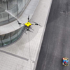 Multi-angle nozzle drone performing facade maintenance