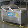 Automatic double chamber vacuum sealing machine for food preservation and industrial packaging applications.
