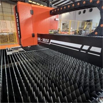Metal parts cut by CNC fiber laser machine showing smooth edges and fine detail quality after high-speed cutting