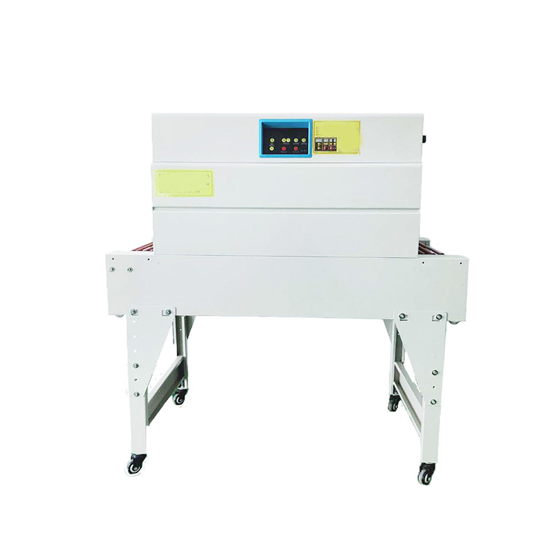 Side view of hot air shrink packaging machine with conveyor belt and tunnel entry